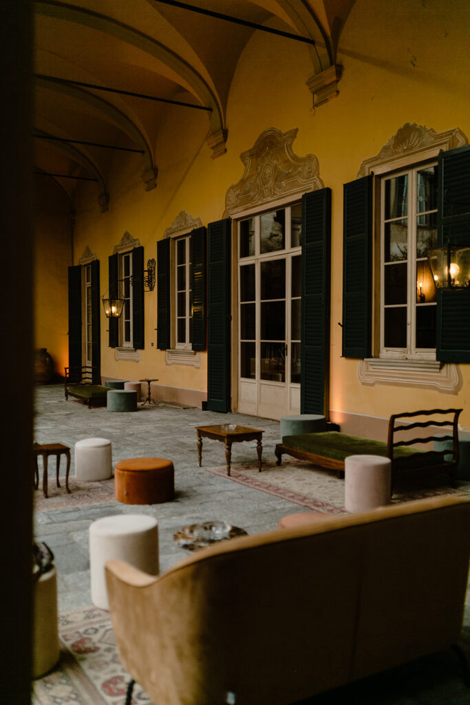 Elegant Italian courtyard terrace with string lights set up for a wedding reception, Marco & Filippo wedding