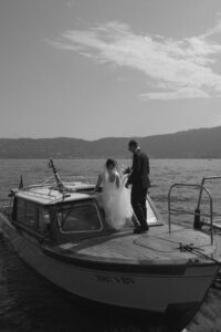 Bride and groom on a boat dock on Lake Garda, Italy